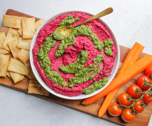 Beet Hummus with Pesto on charcuterie board