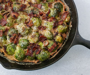 Creamy Bacon Brussel Sprouts in a cast iron pan